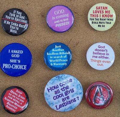 A collection of atheist buttons